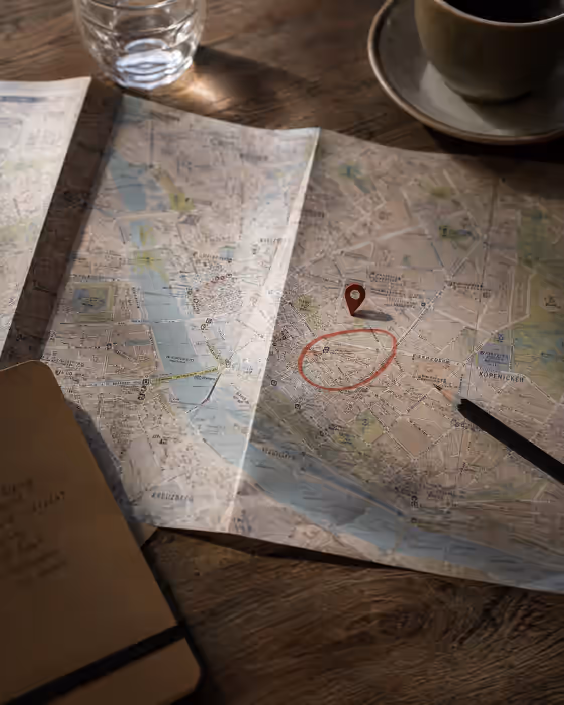 City map on a table with a marked location pin